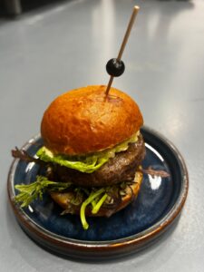 Beef burger with caramelized red onions on a brioche bun