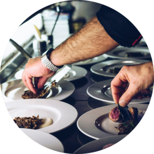 Chefs preparing plates for a dinner catering