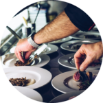 Chefs preparing plates for a dinner catering