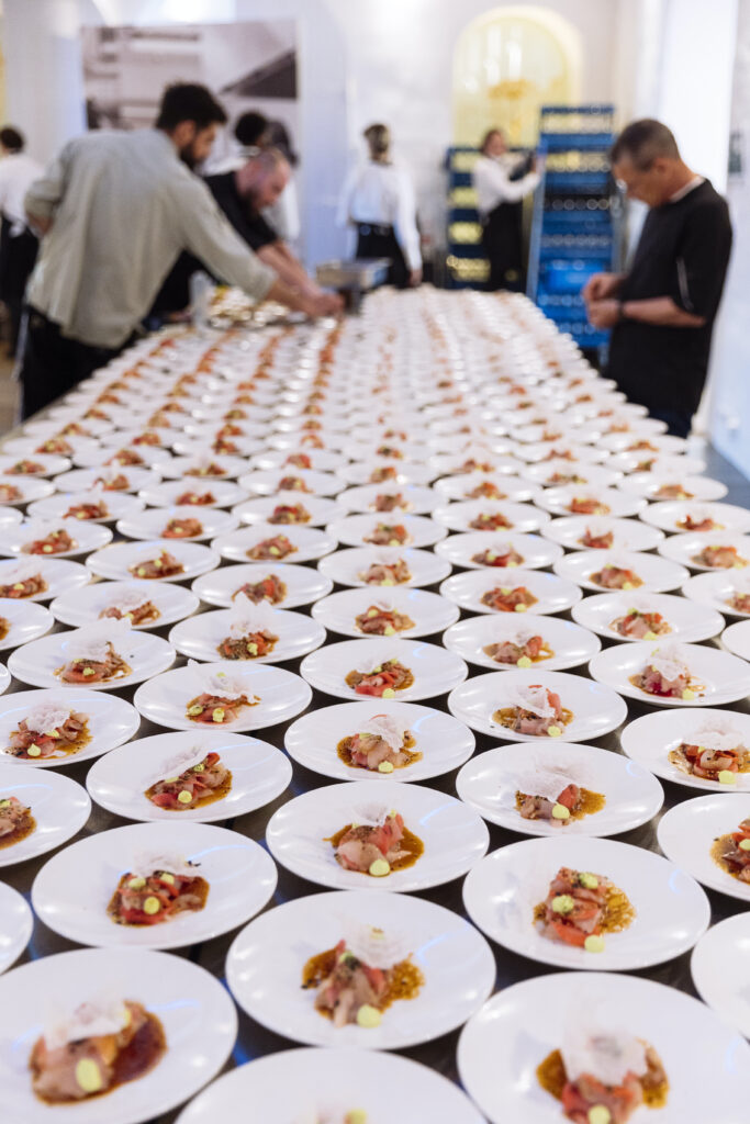 Chefs prepare appetizers for a sit down dinner for 200 guests.